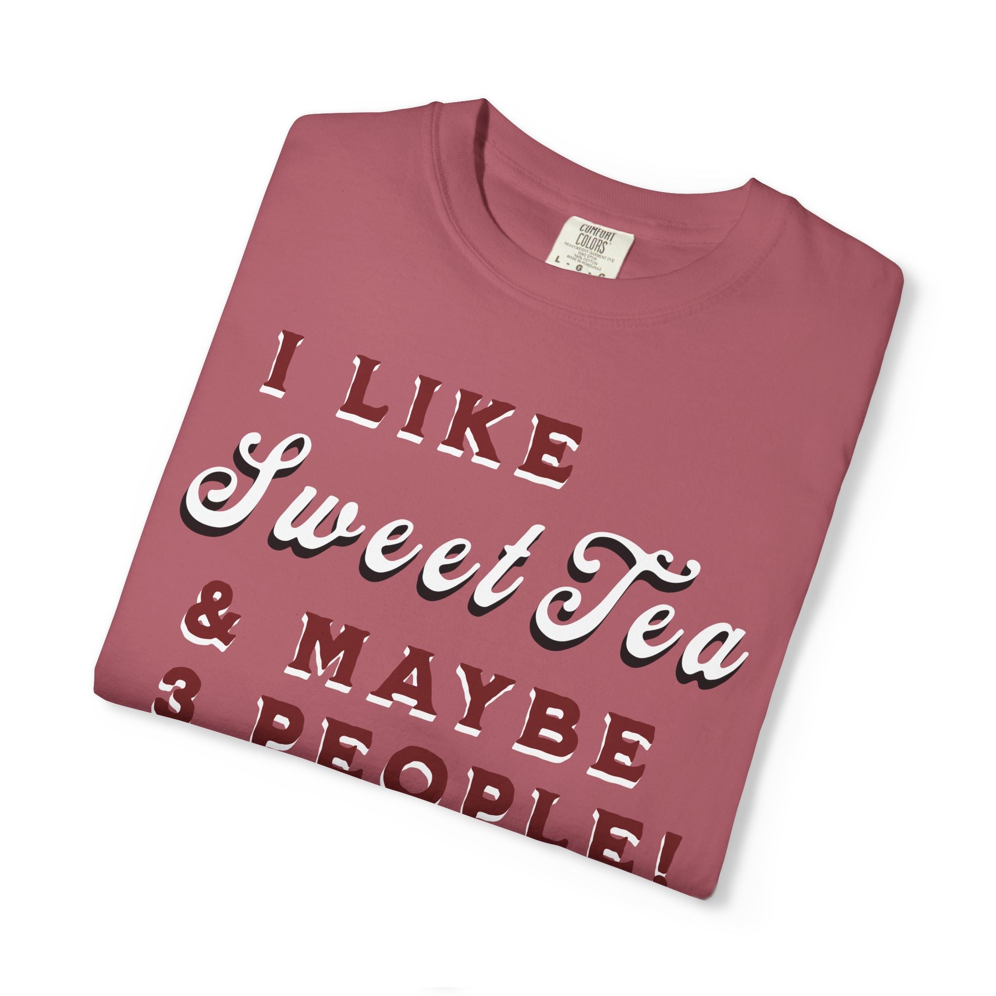 Folded maroon t-shirt with text 'I LIKE Sweet Tea & MAYBE 3 PEOPLE!' on a white background