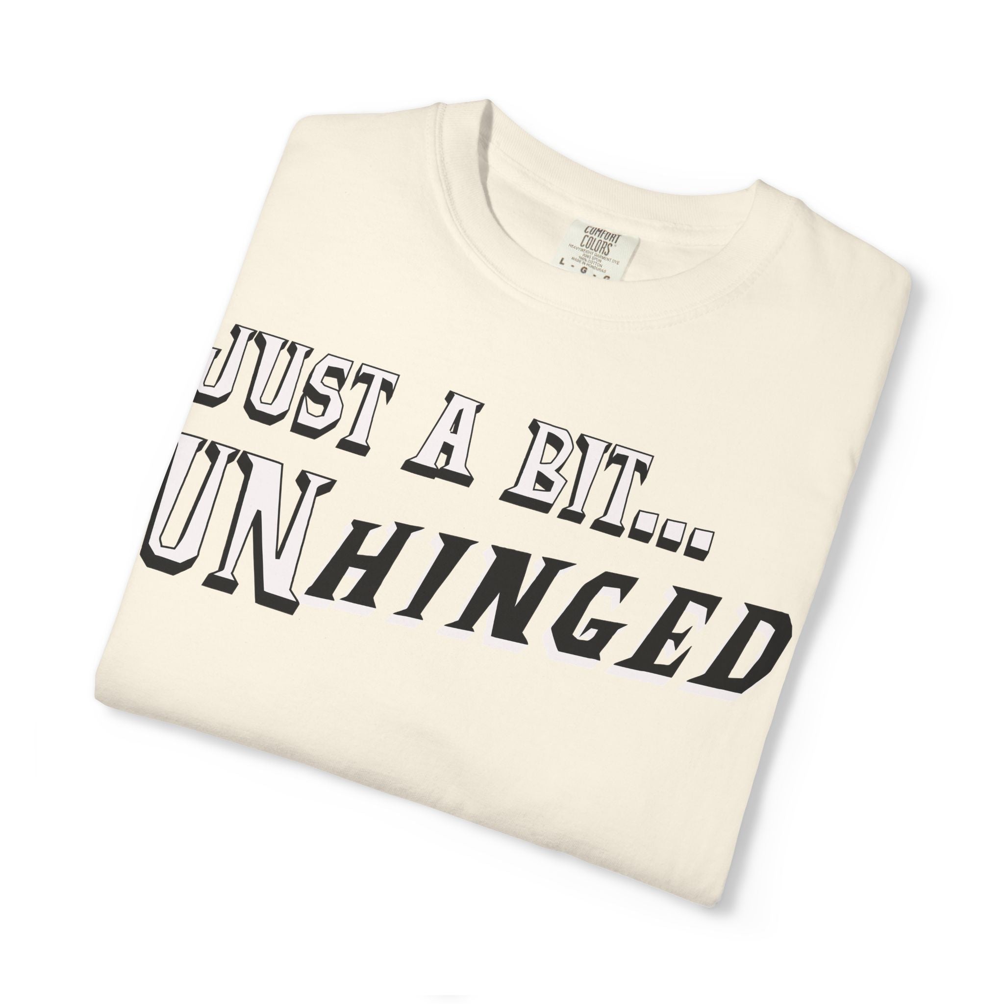 Folded t-shirt with 'Just a Bit... Unhinged' text on a white background