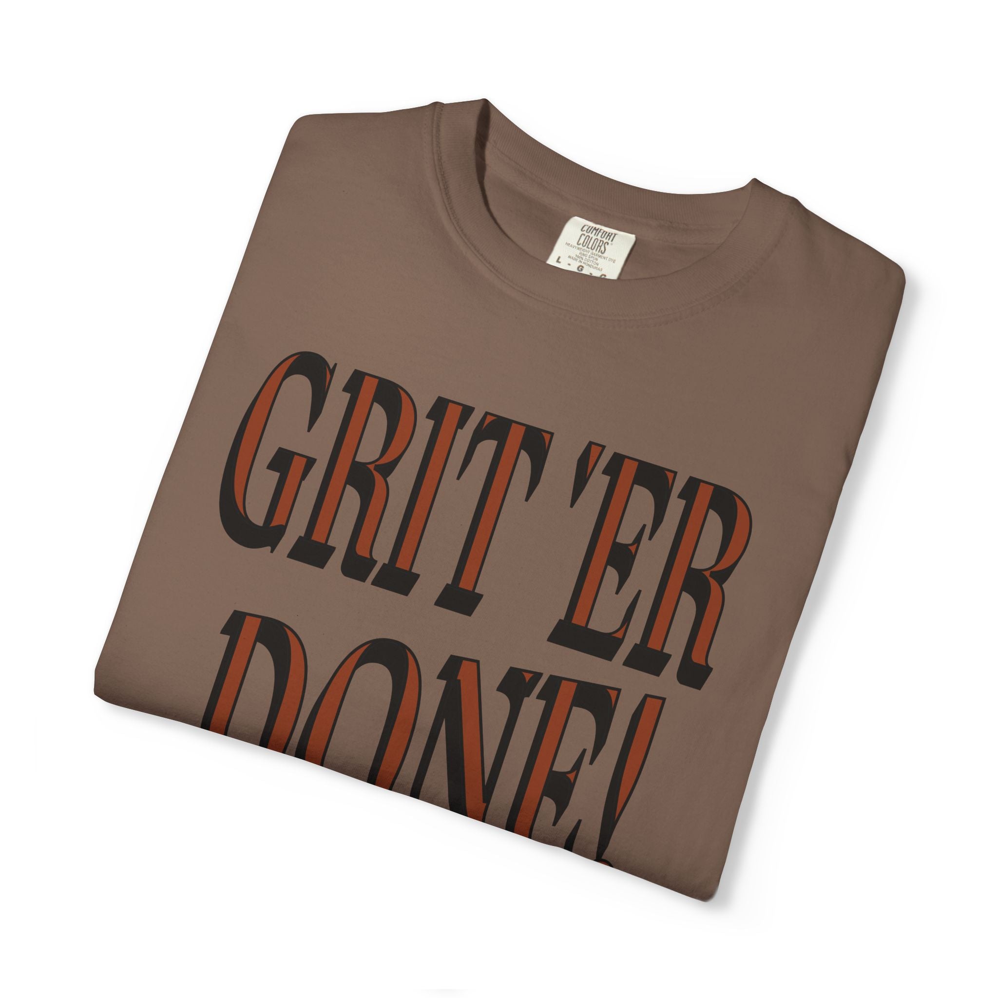 Folded brown t-shirt with 'GRIT'ER DONE!' text on a white background