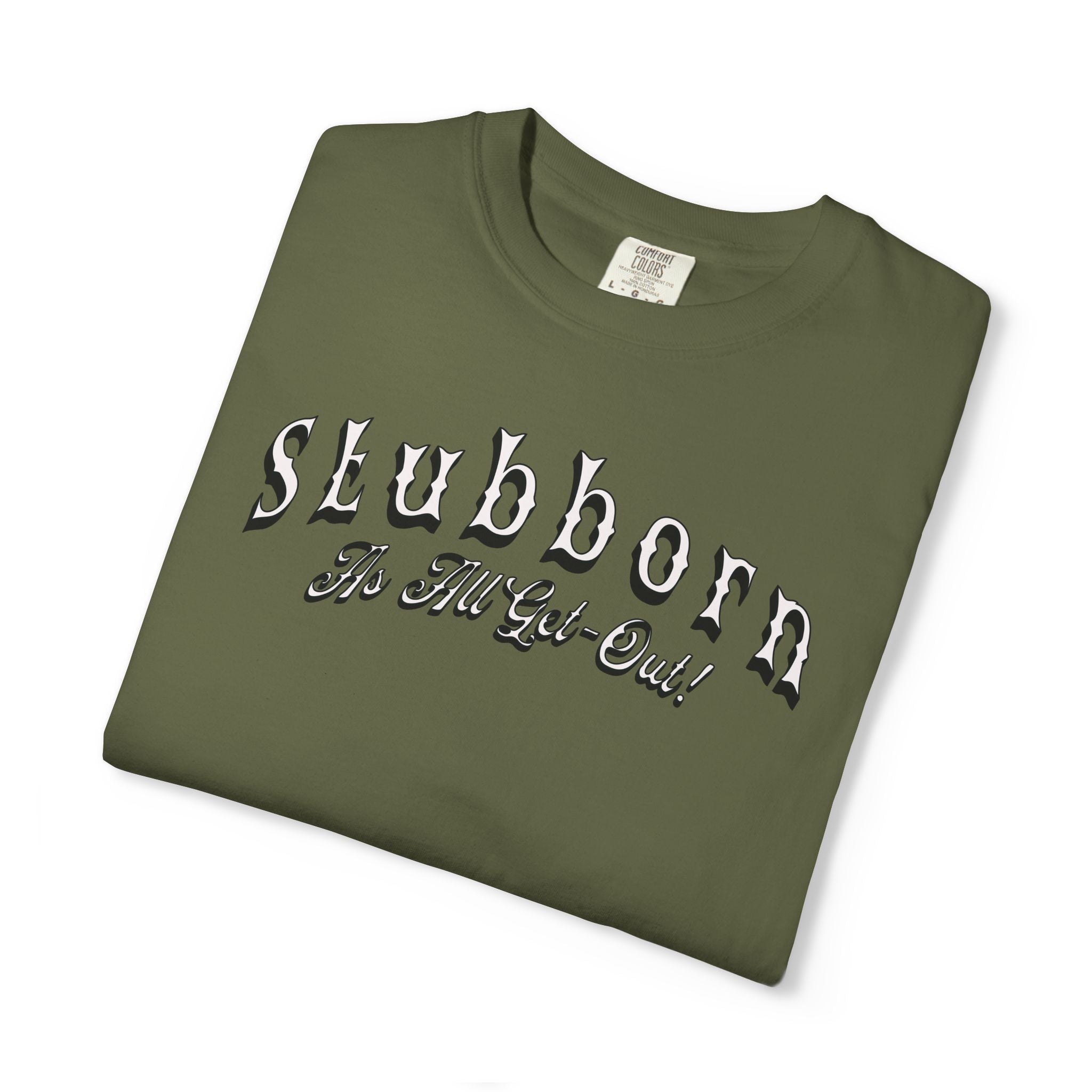 Folded green t-shirt with 'Stubborn The Hell Got Out!' text on a white background
