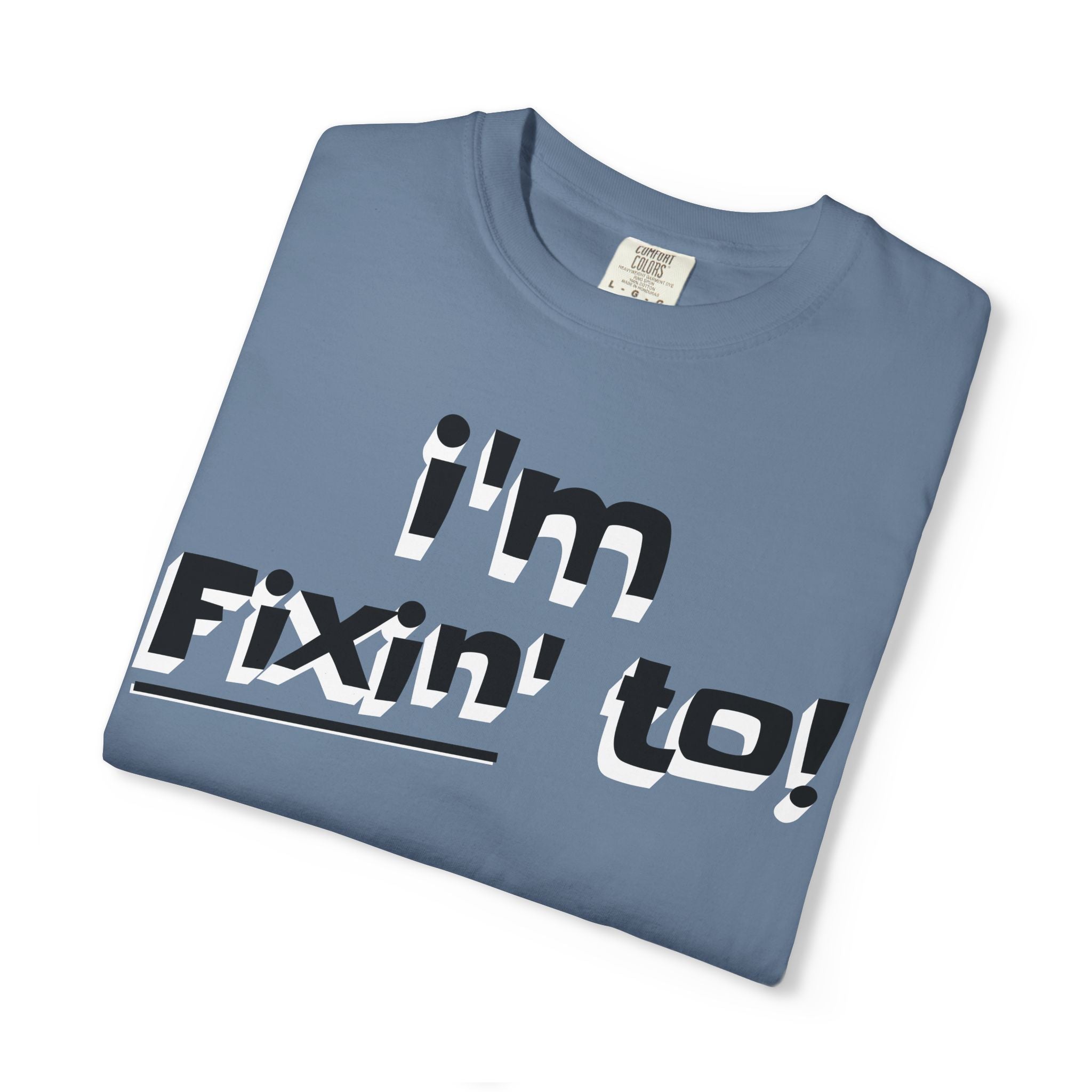 Folded blue t-shirt with 'i'm Fixin' to!' text on a white background