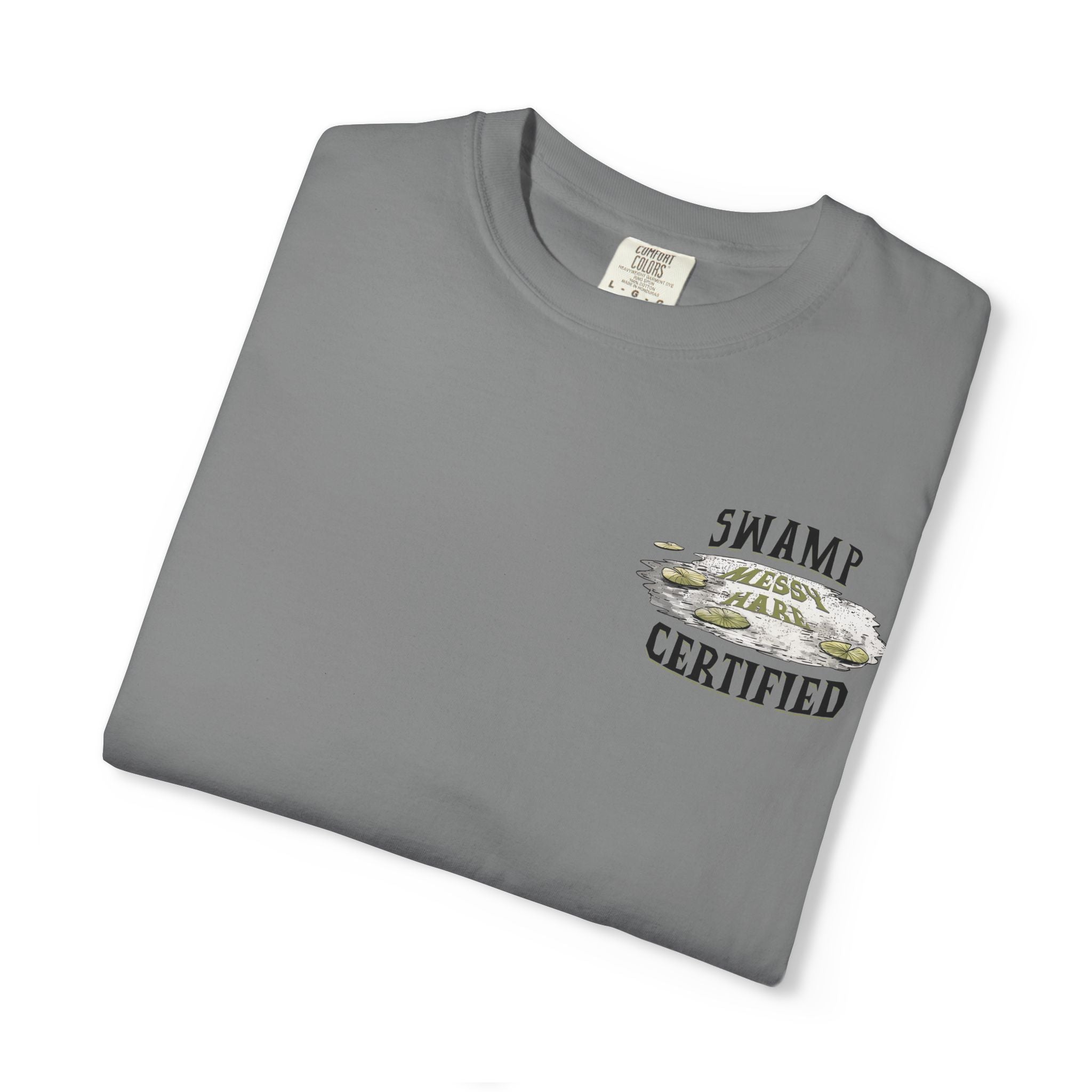 Folded gray t-shirt with 'Swamp Messy Hair Certified' text and graphic on a white background