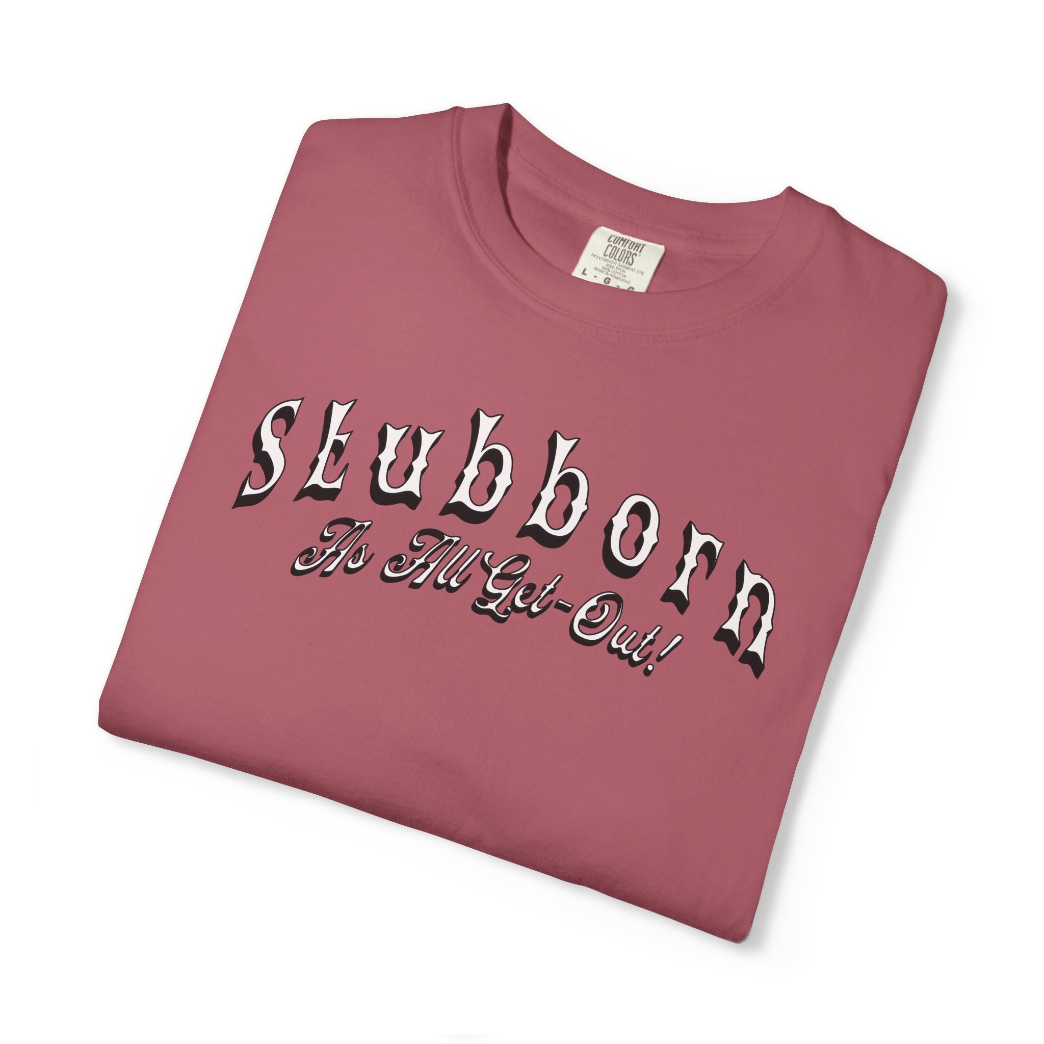 Folded maroon t-shirt with 'Slubborn The Hill Got Out!' text on a white background