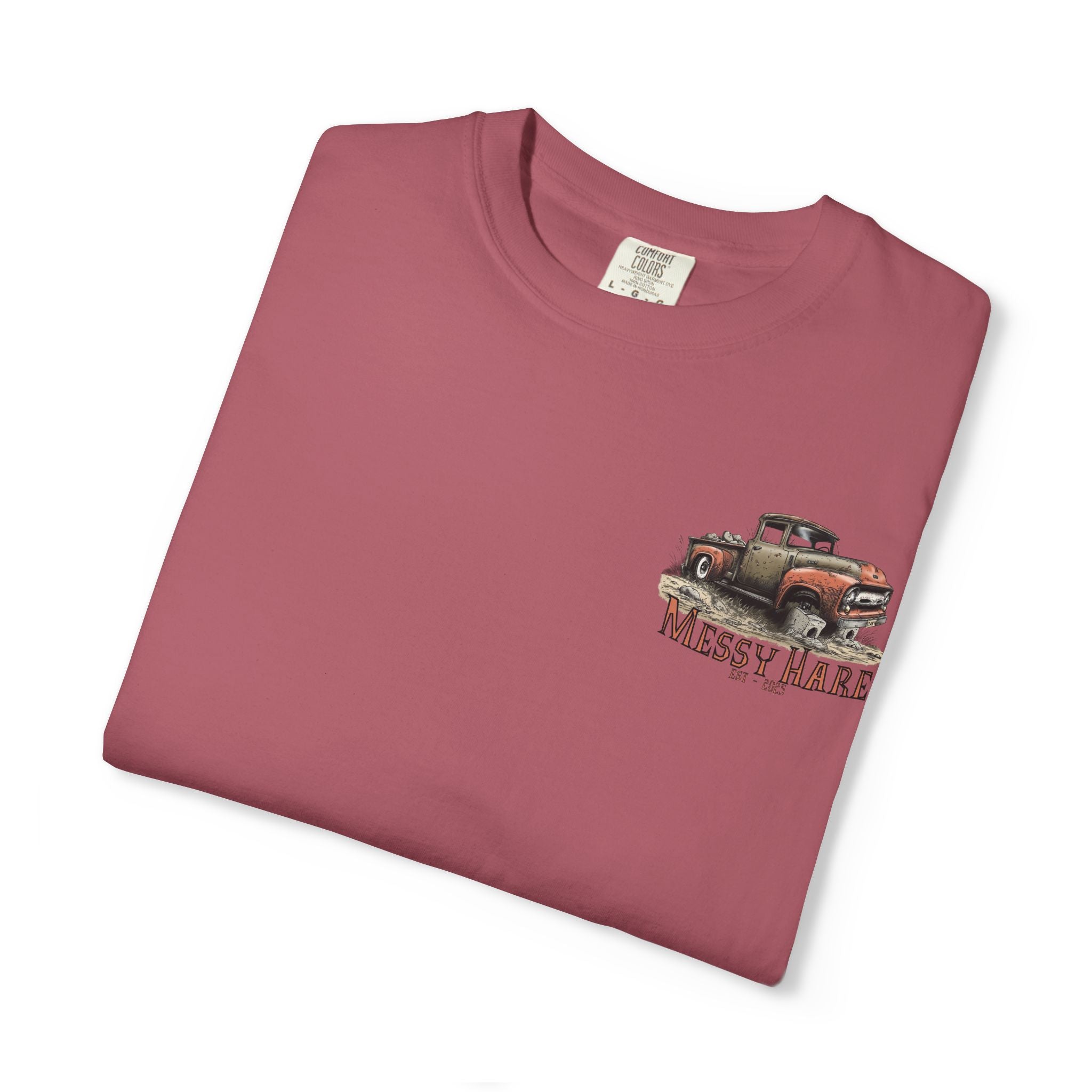 Folded maroon t-shirt with a graphic of an old truck and 'Messy Mare' text on a white background
