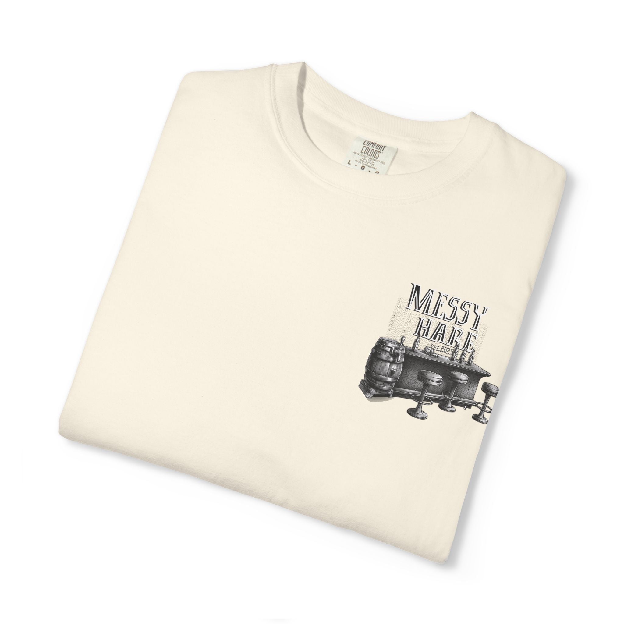 Folded cream-colored t-shirt with a graphic design and text on a white background
