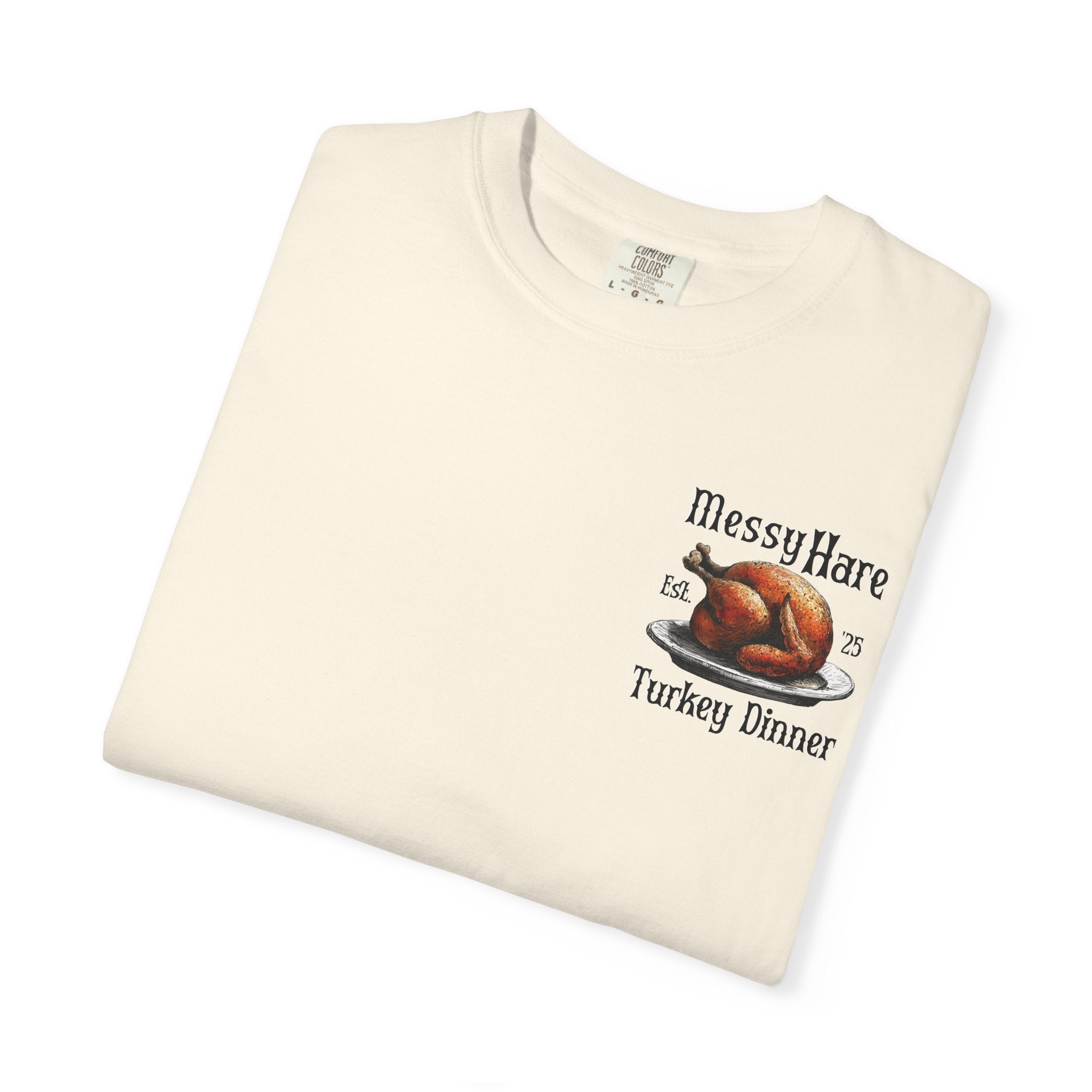 Folded cream-colored t-shirt with a graphic of a roasted turkey and text on a white background