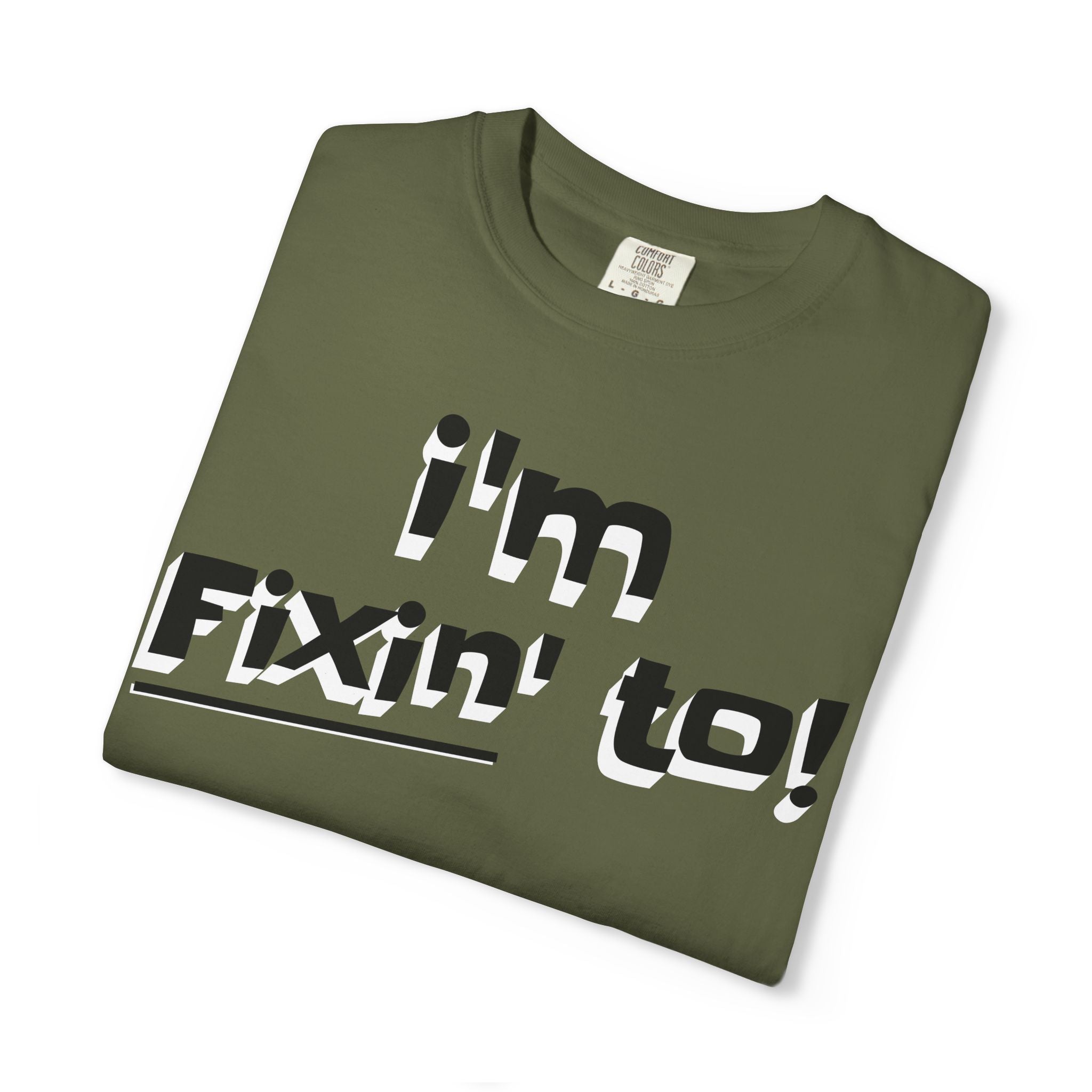 Folded green t-shirt with 'I'm Fixin' to!' text on a white background