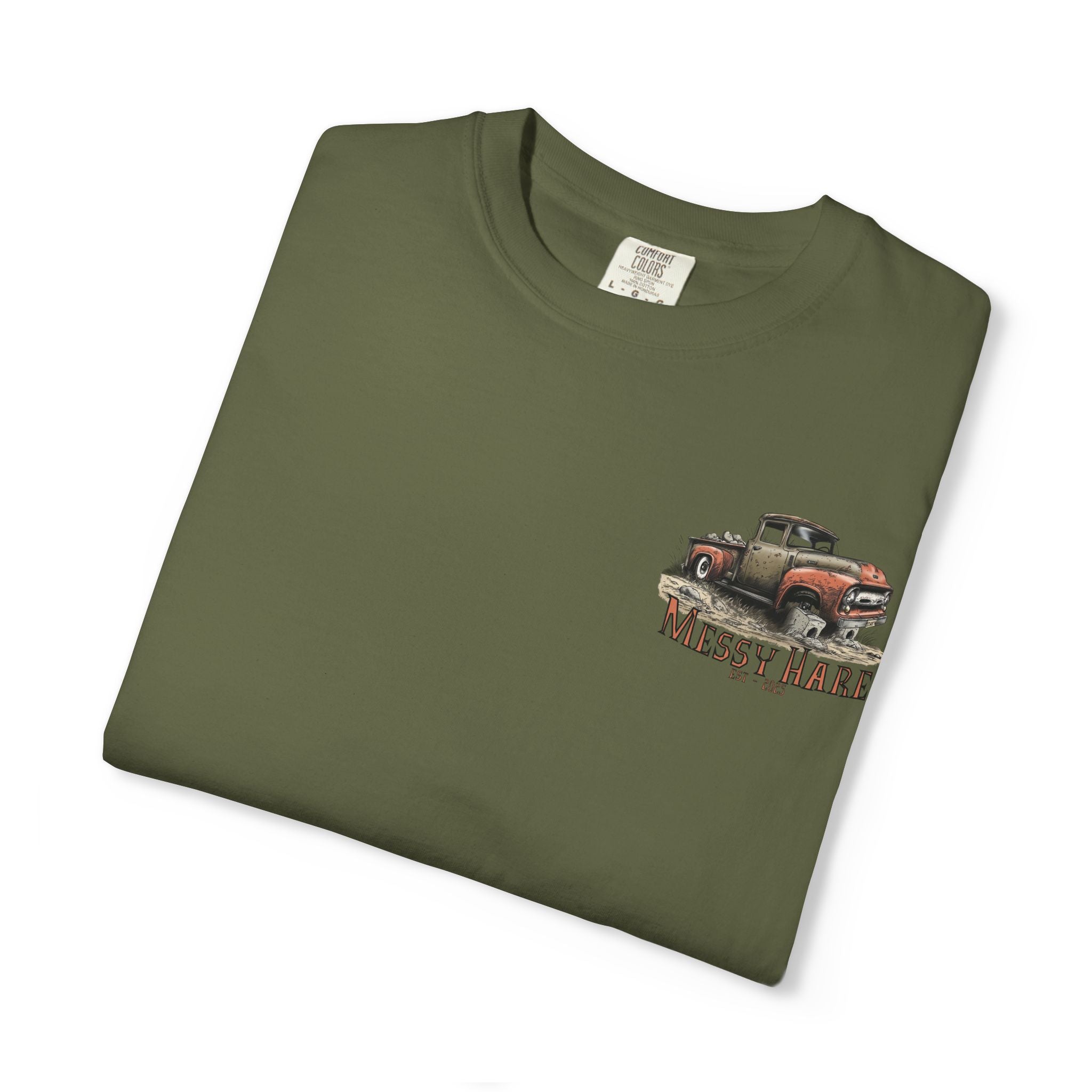 Folded green t-shirt with a graphic of two vintage trucks on a white background