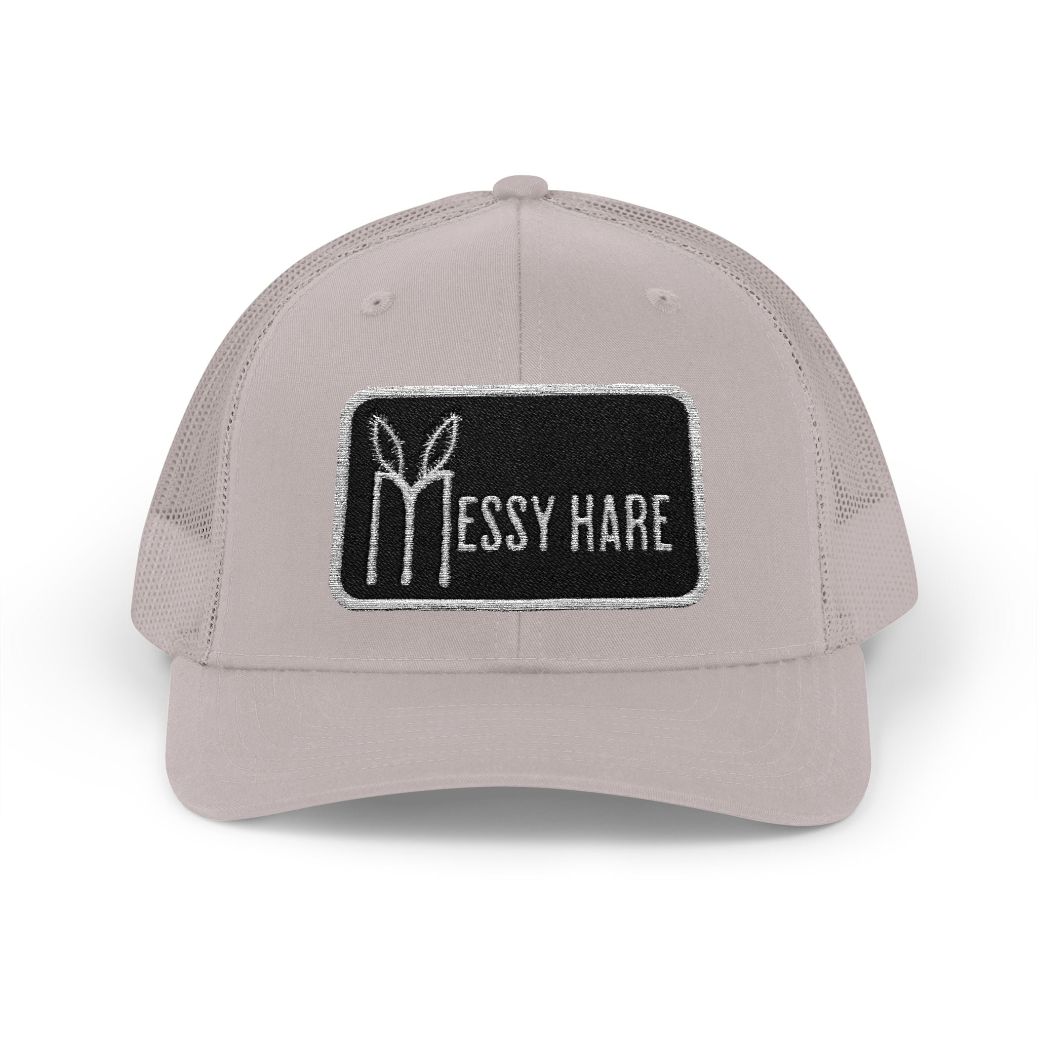 Beige cap with a black patch featuring 'Messy Hare' logo on a white background