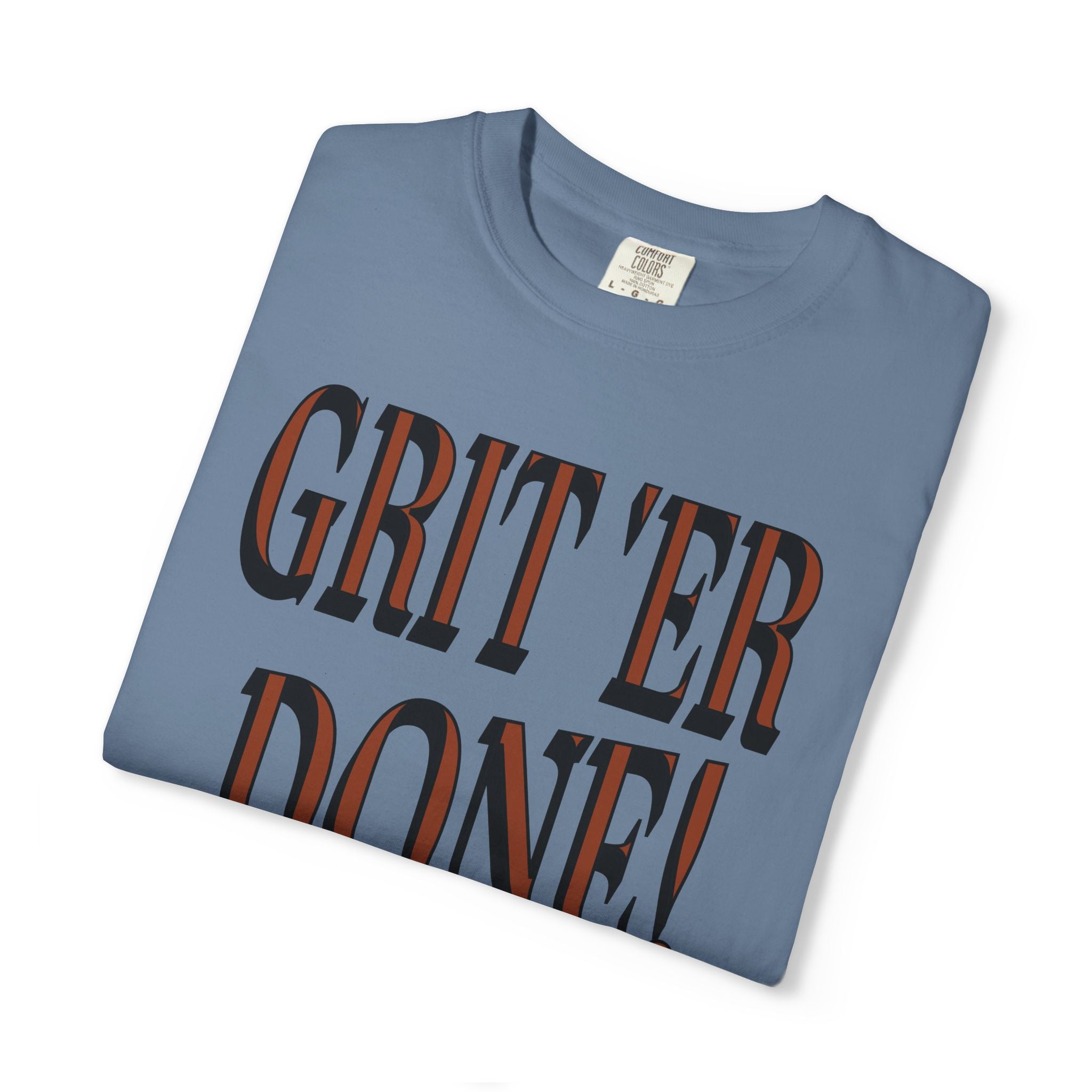 Folded blue t-shirt with 'GRIT'ER DONE!' text on a white background