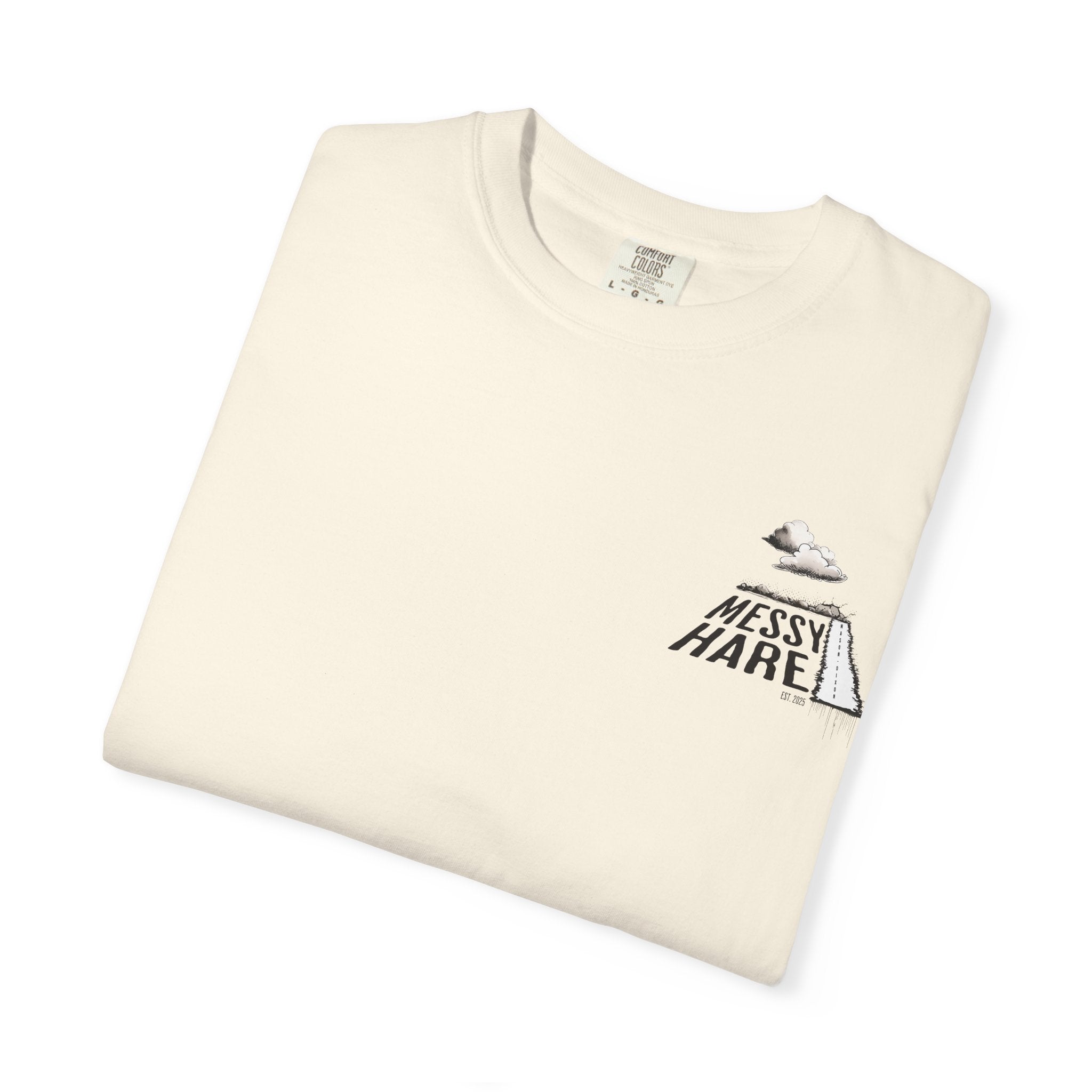 Folded cream-colored t-shirt with 'Messy Hare' logo on a white background