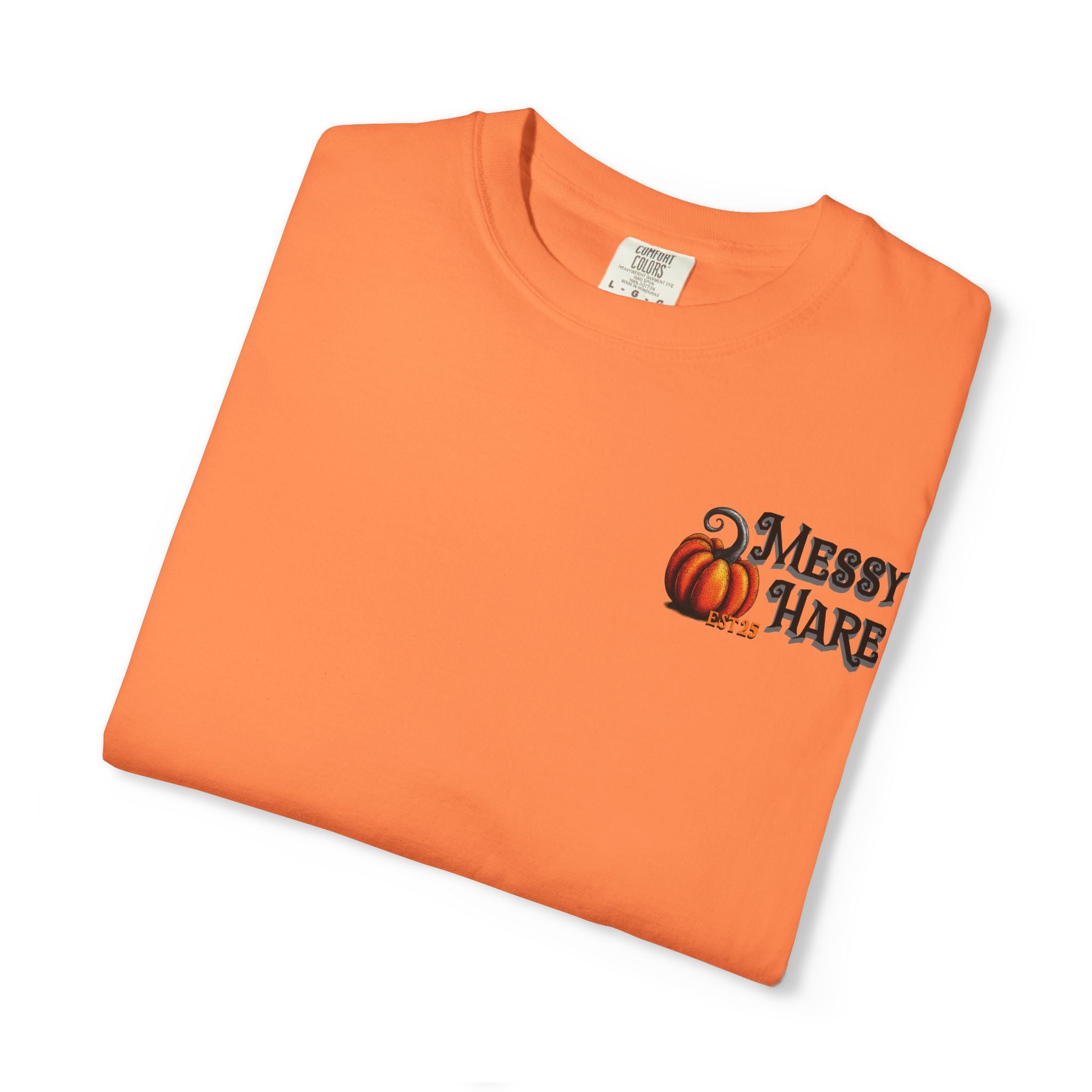 Folded orange t-shirt with 'Messy Hare' design on a white background