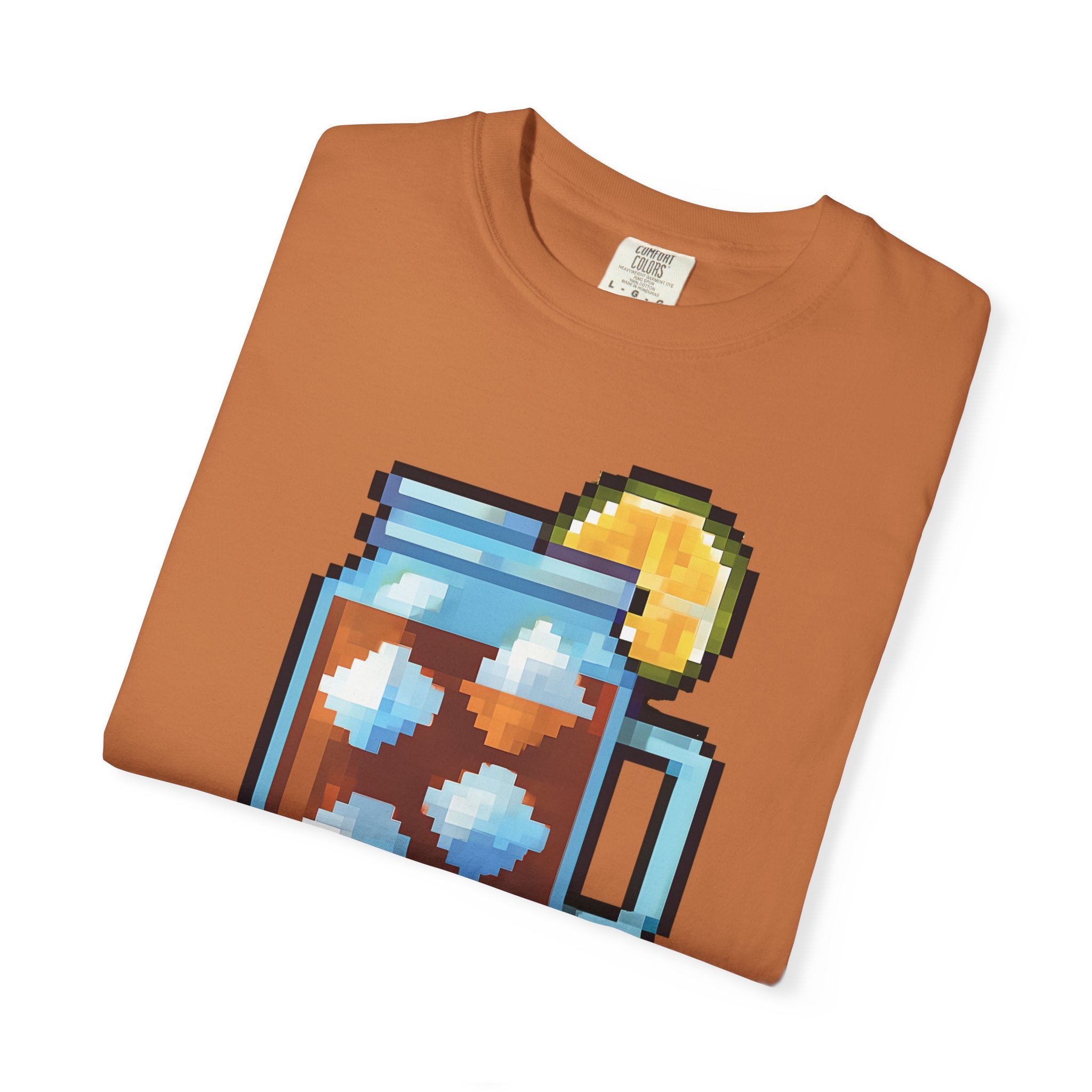 Folded brown t-shirt with pixel art design of a house and sun on a white background