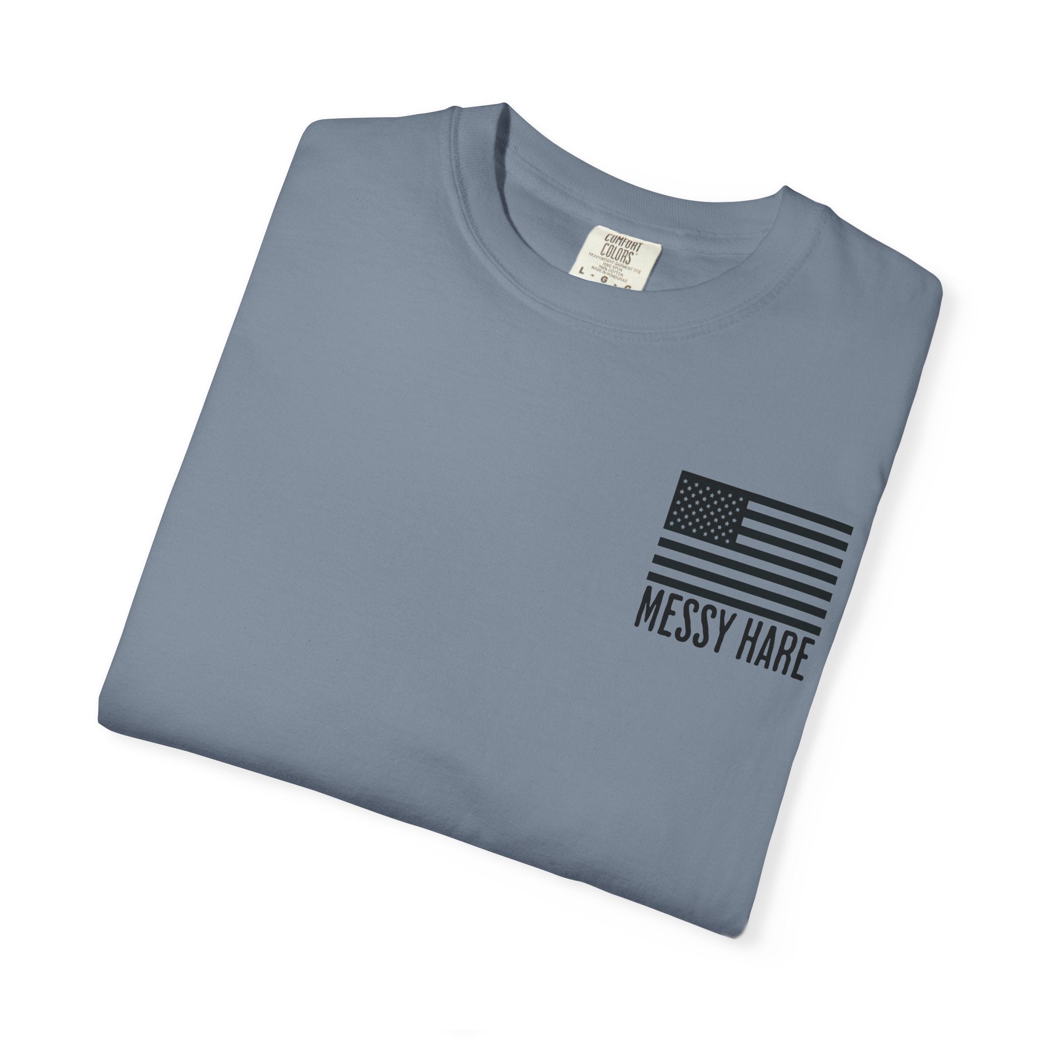 Folded blue t-shirt with American flag and 'Messy Hare' text on a white background