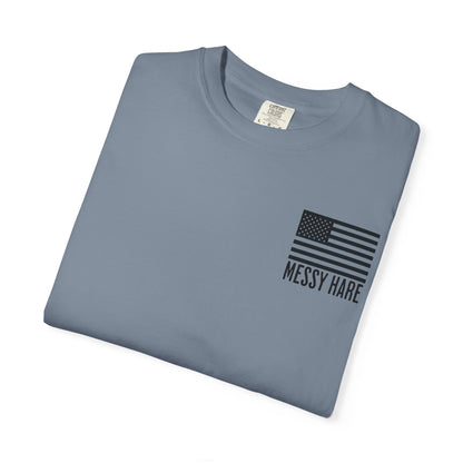 Folded blue t-shirt with American flag and 'Messy Hare' text on a white background