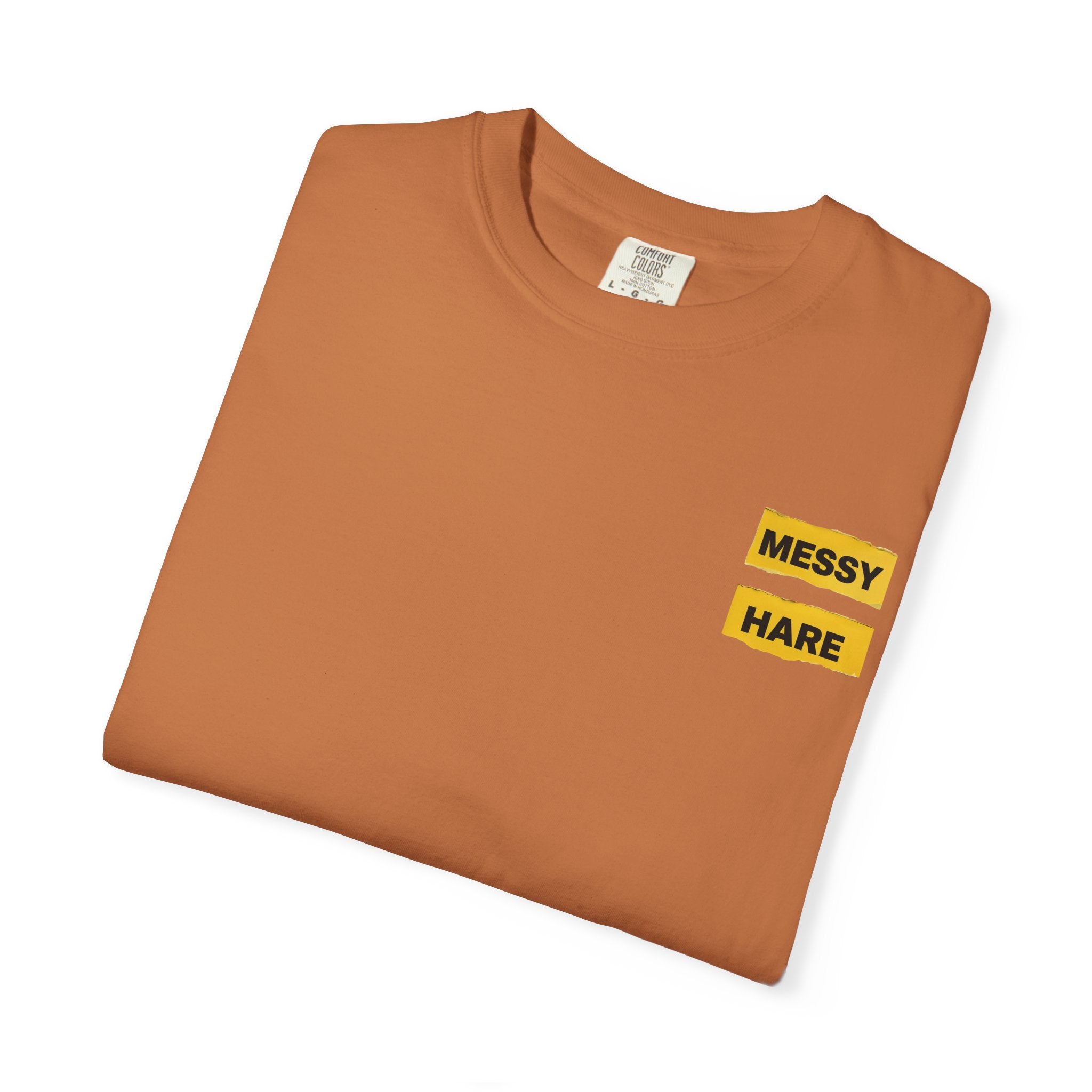 Folded brown t-shirt with 'Messy Hare' text on a white background