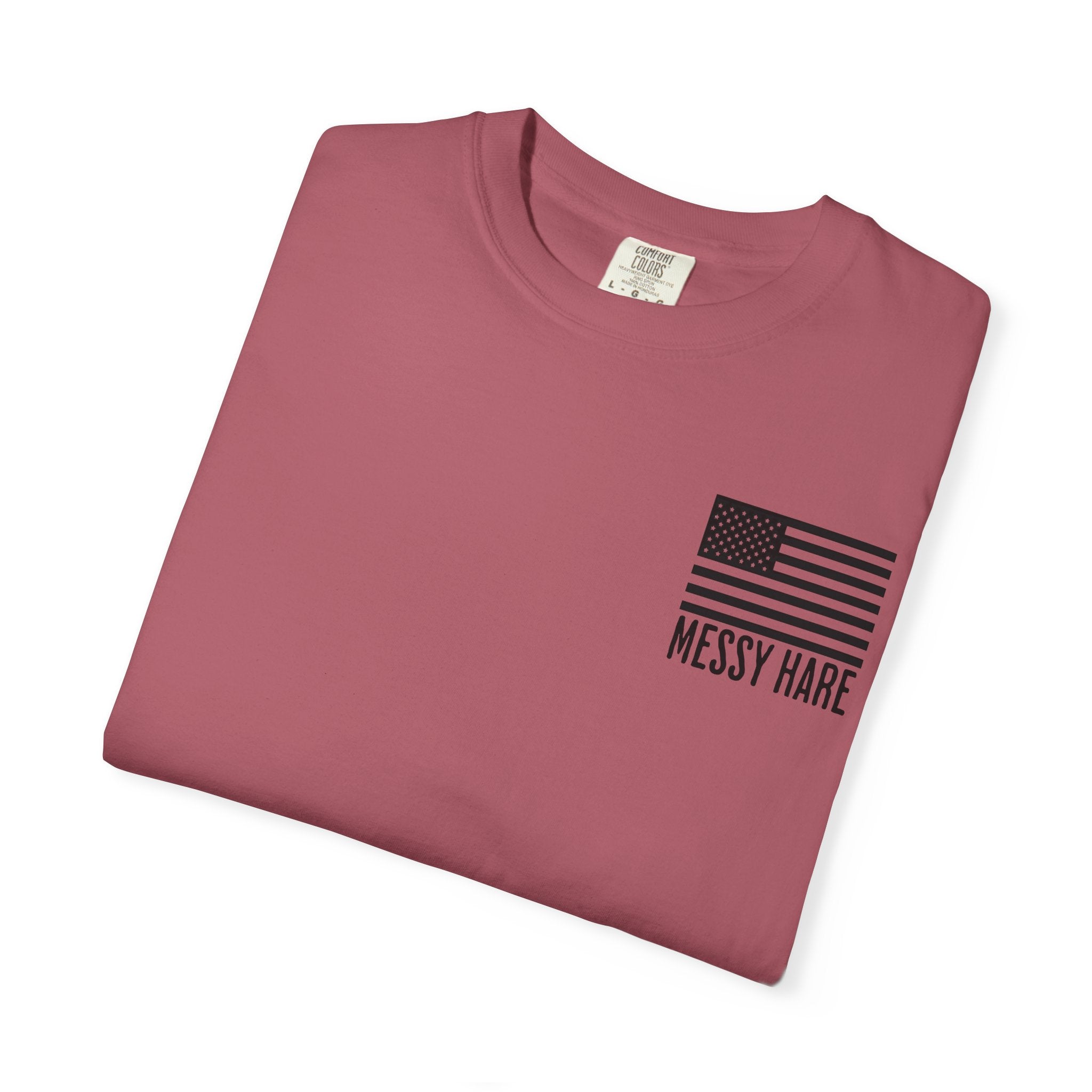 Folded maroon t-shirt with American flag and 'Messy Hare' text on a white background