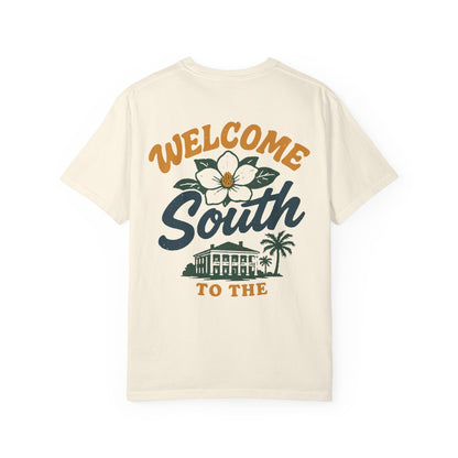 Beige t-shirt with 'Welcome South to the' graphic design on a white background