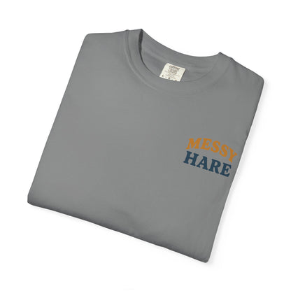 Folded gray t-shirt with 'Messy Hare' text on a white background