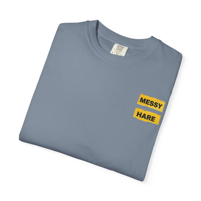 Folded Blue jean colored t-shirt with 'Messy Hare' text in yellow on a white background