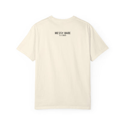 Beige t-shirt with 'Messy Hare' logo on the back against a white background