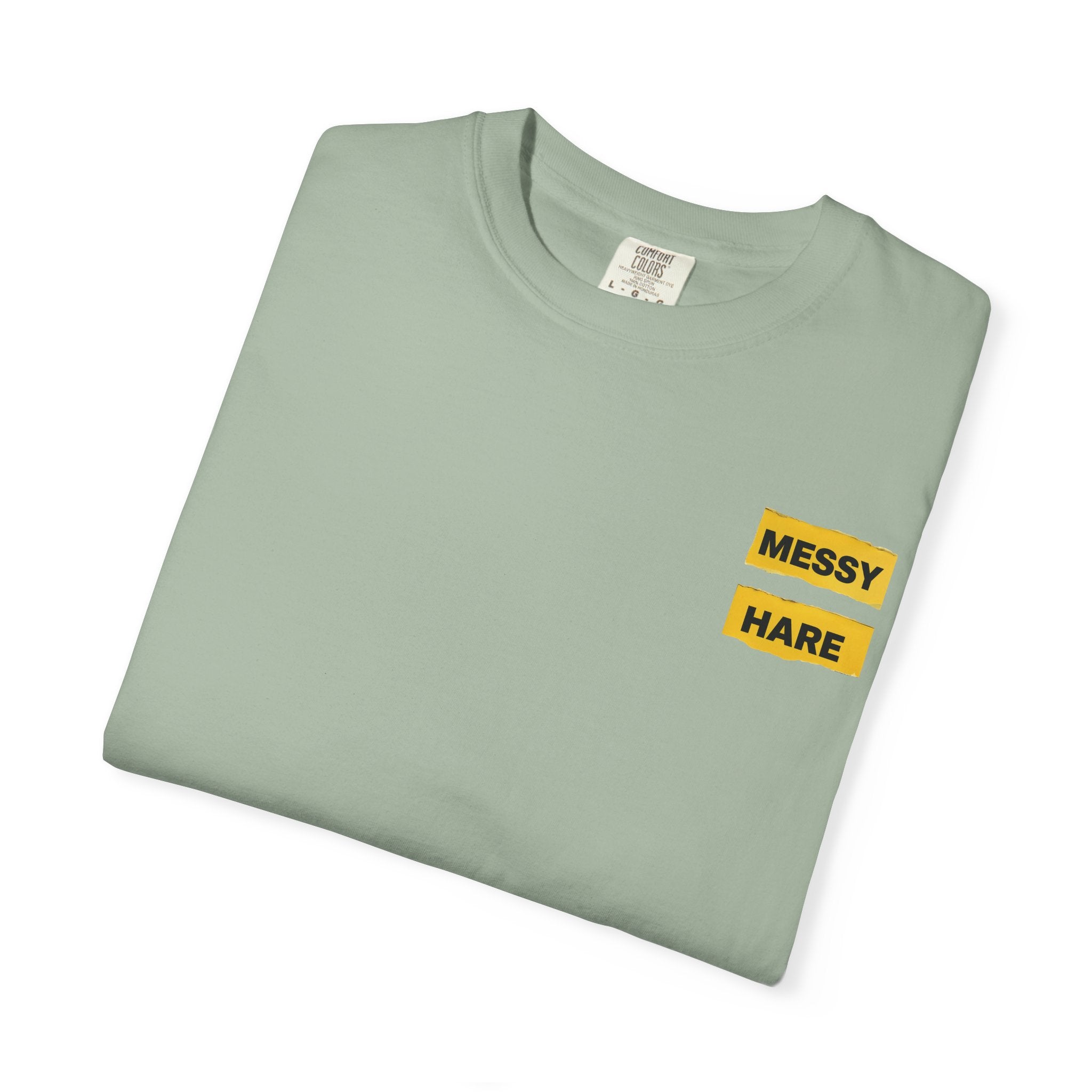 Folded light green t-shirt with 'Messy Hare' text on a white background