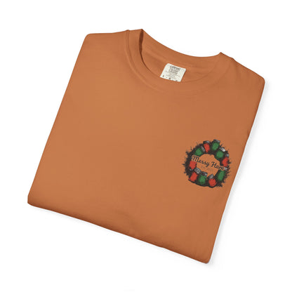Folded brown t-shirt with a Christmas wreath design on a white background