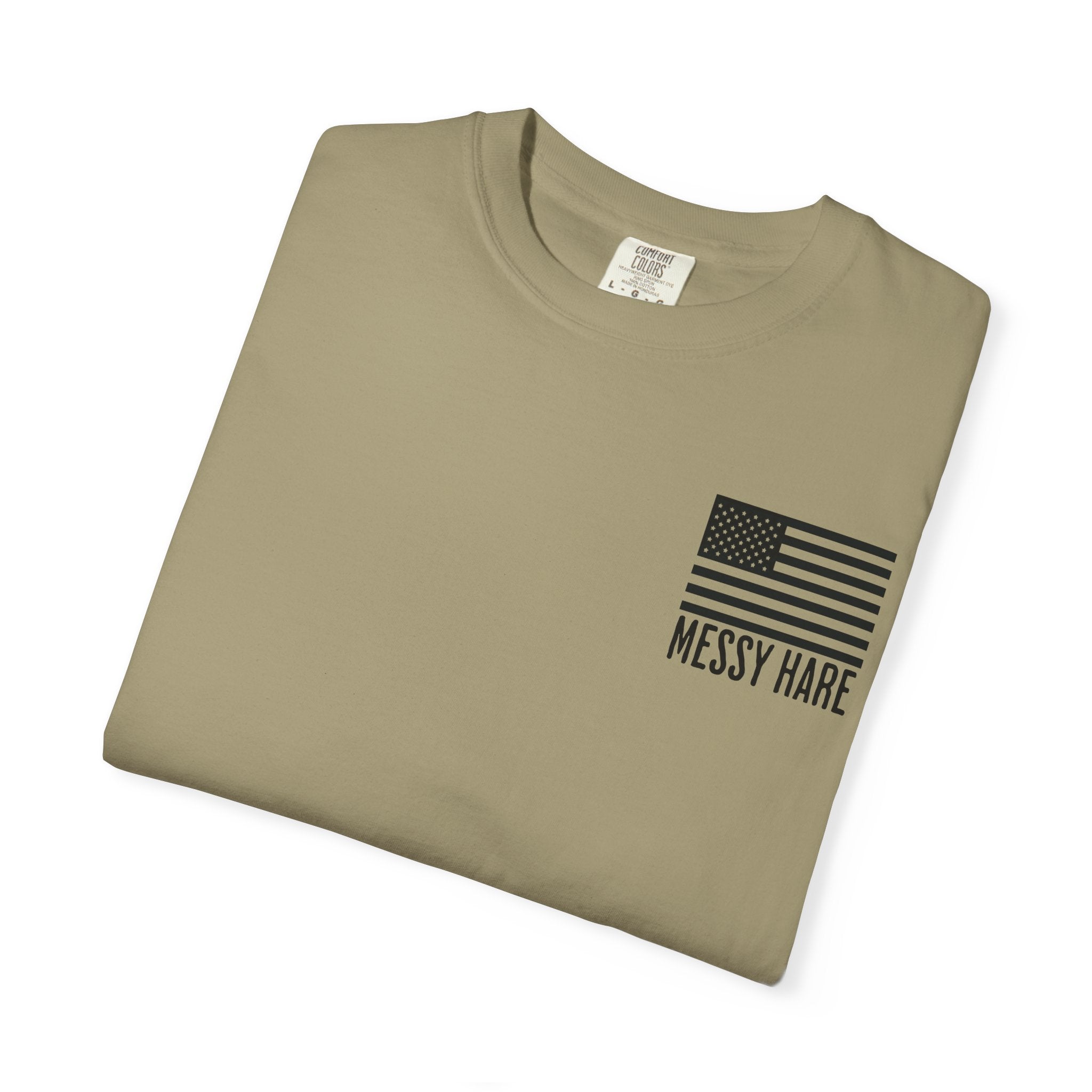 Folded khaki t-shirt with American flag and 'Messy Hare' text on a white background