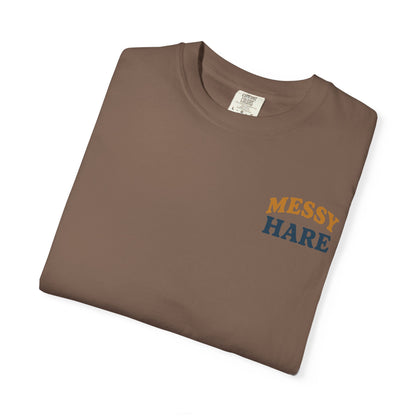 Folded brown t-shirt with 'MESSY HARE' text on a white background