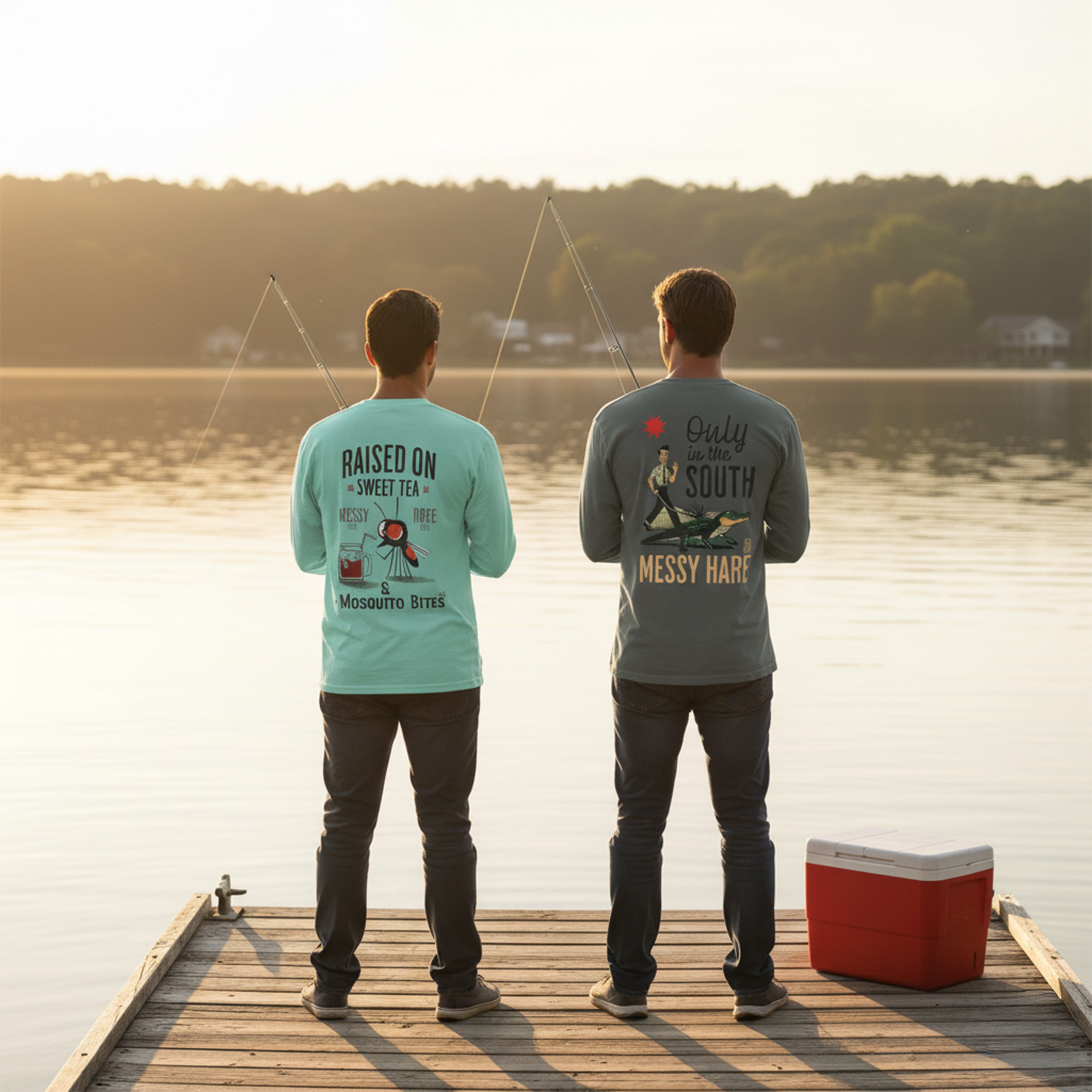 Two people standing on a dock by a lake, wearing t-shirts with text and graphics.