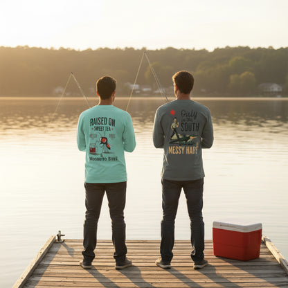 Two people standing on a dock by a lake, wearing t-shirts with text and graphics.