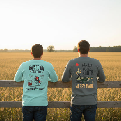 Two people wearing t-shirts with 'Messy Hare' branding, standing in a field.